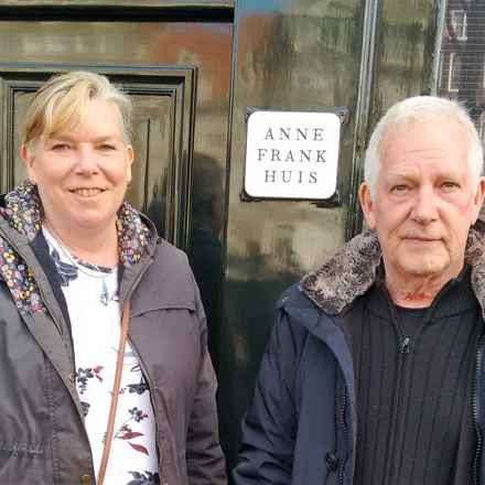 Anne, left, pictured with John on holiday outside the Anne Frank house museum