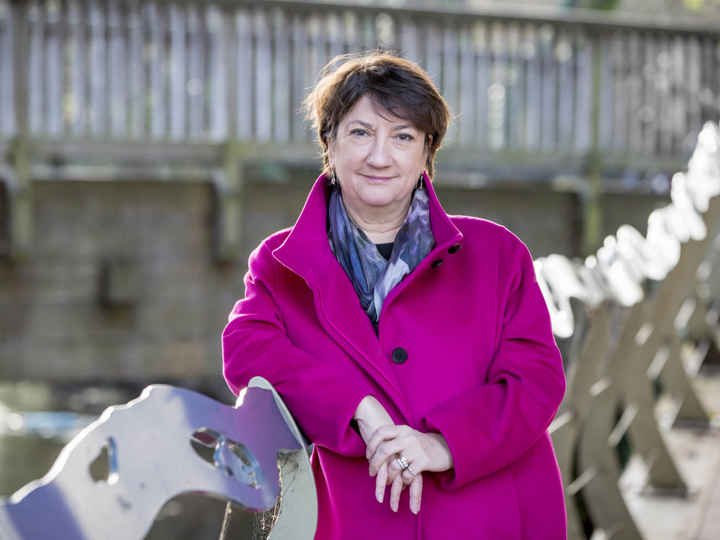 Cathy Yelf, leaning on side of bridge