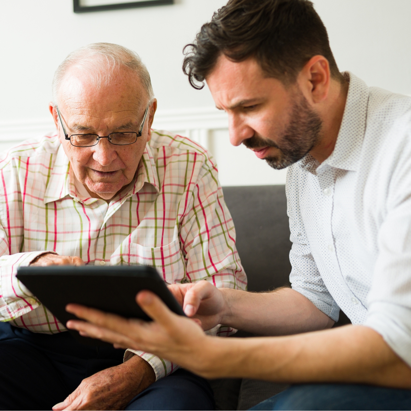 A dad and son use a tablet computer