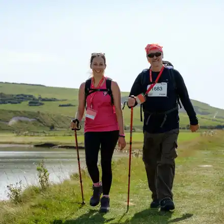 A woman and a man in sunglasses and walking gear on the Lake District challenge