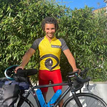 Man in Macular Society t-shirt with bicycle 