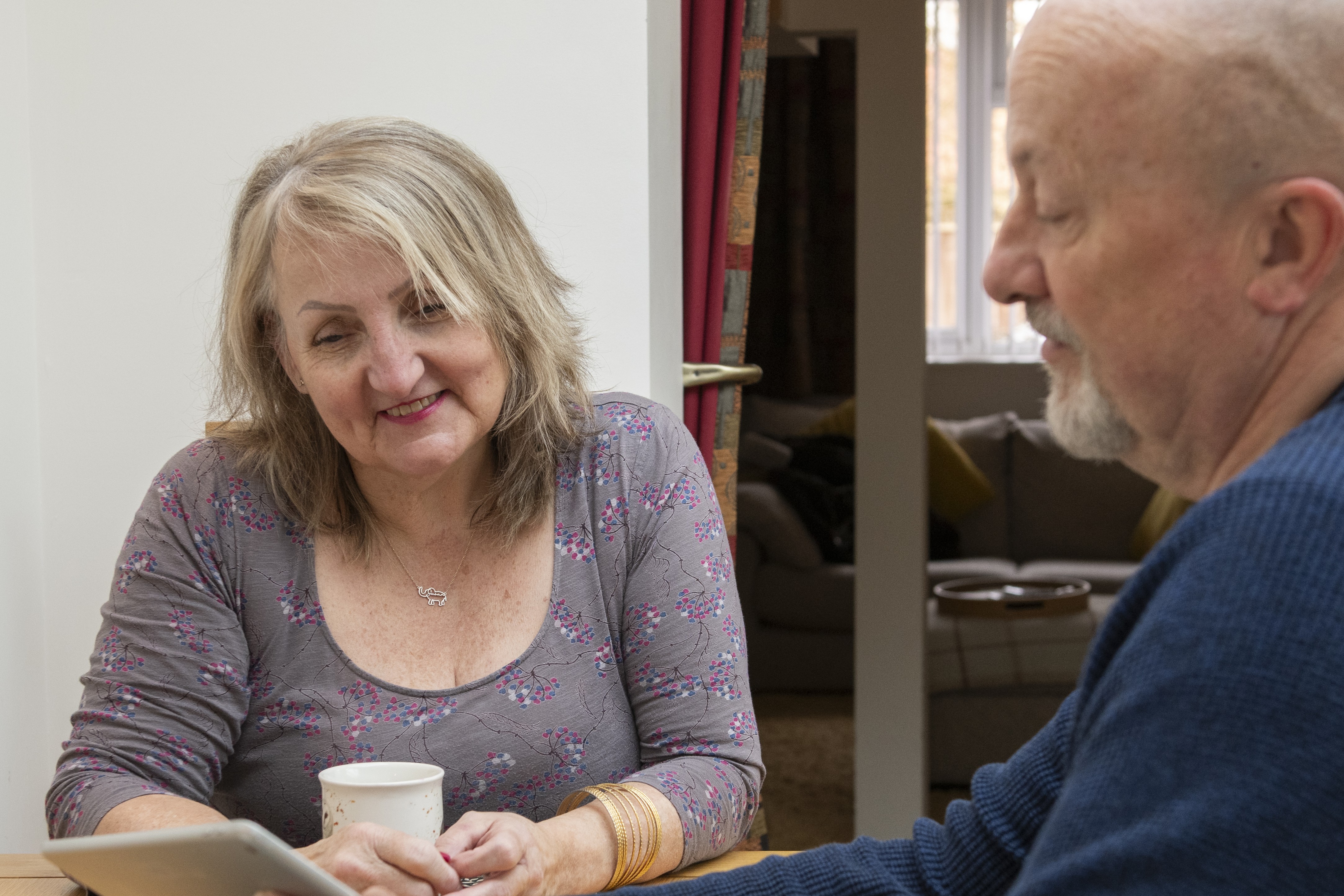 Sue with her husband looking at a tablet together
