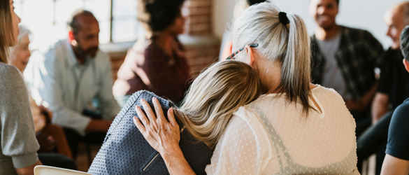 Support group consoling hug