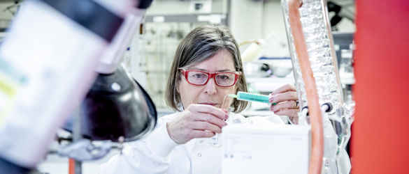 Researcher Dr Mulholland with pipette in the laboratory
