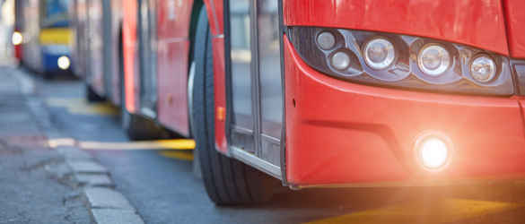 Red bus next to kerb