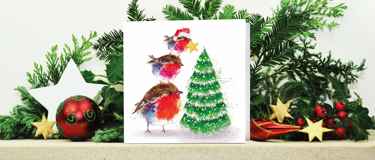 Fluffy robin family tree Christmas card on decorated mantle
