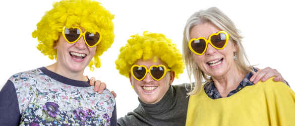 Three people wearing yellow wigs and sunglasses