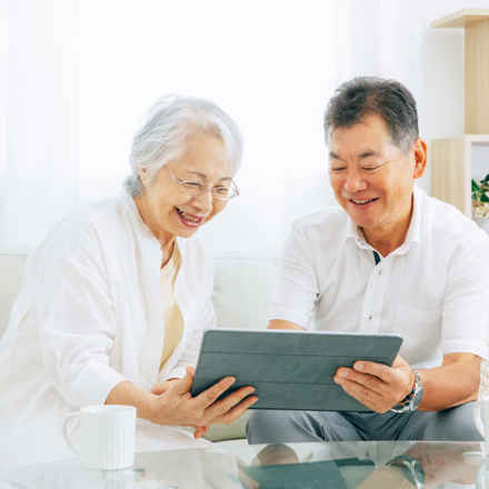 Male and female using tablet smiling.jpeg