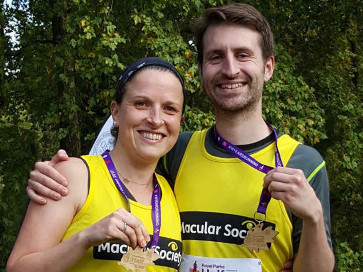 Two runners with vests and medals