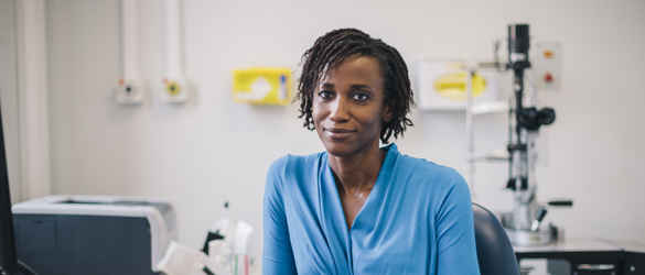 Female consultant, leaning one arm on desk.
