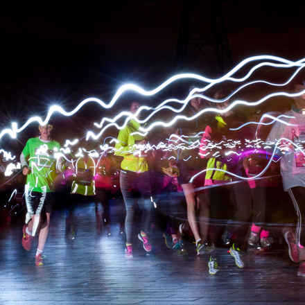 Runners in the dark with day glow lights at Supernova