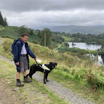 Peter walking around Tarn Hows with his guide dog, Vance.