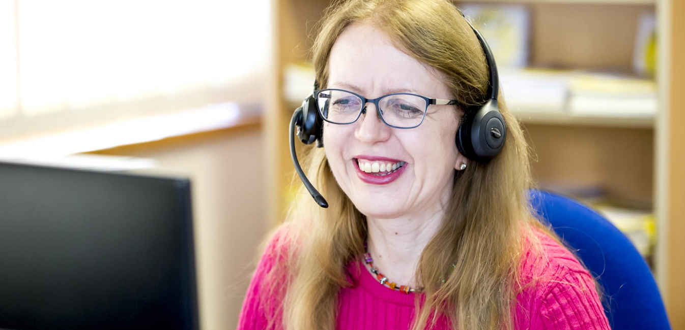 staff member on phone smiling