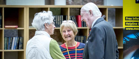 Three elderly individuals talking
