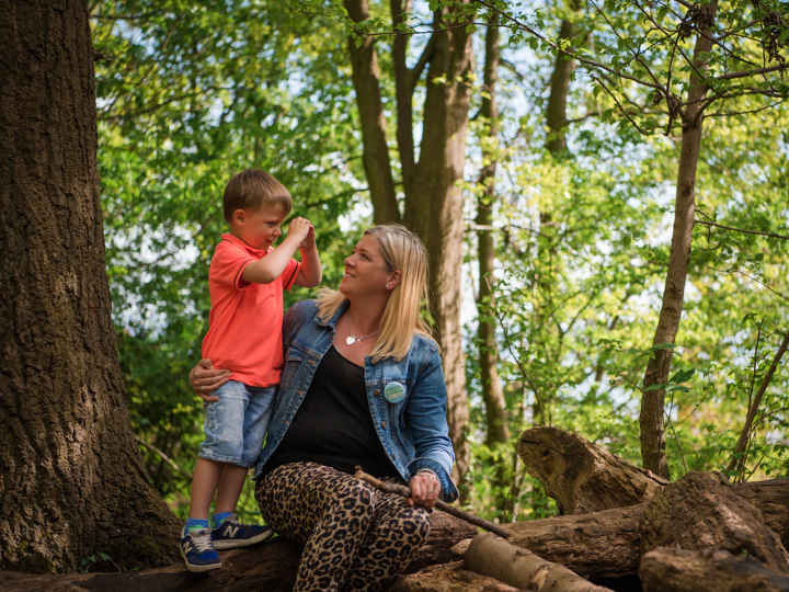 Kelly and her son sitting in the woods