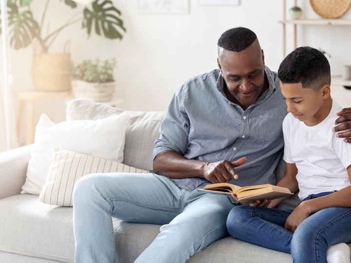 Man and boy reading together