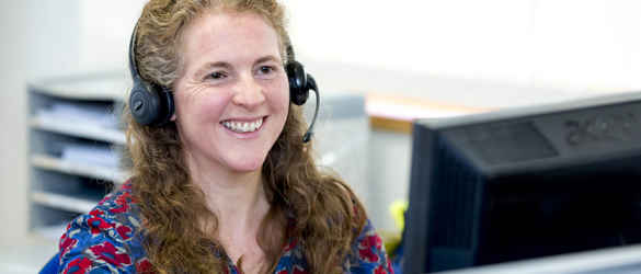 staff member on phone smiling
