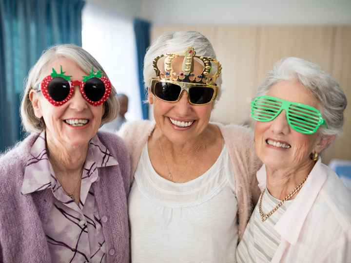 Three smiling ladies with fun sunglasses