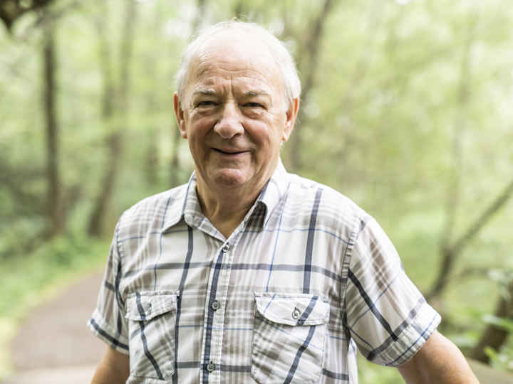 Elderly man smiling outside