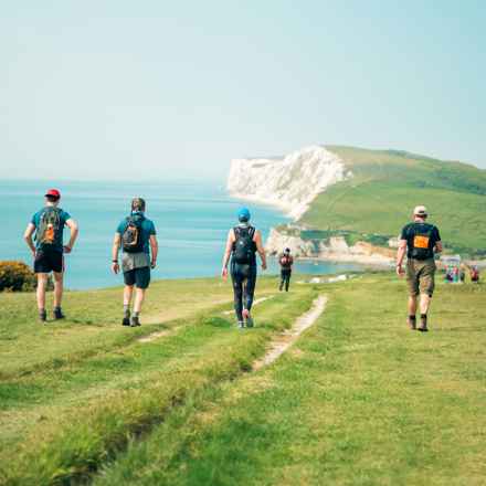 Partipants of the Isle of Wight Challenge with cliff views over the ocean