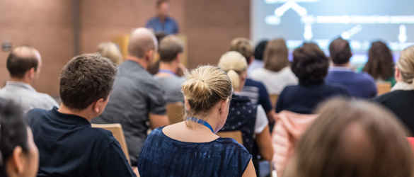 people seated looking at a projector