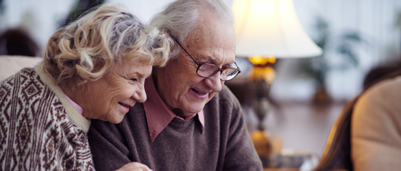 Elderly couple looking at a tablet