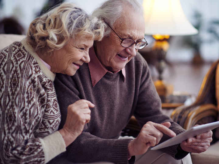 Elderly couple looking at a tablet