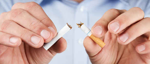 Hands breaking a cigarette