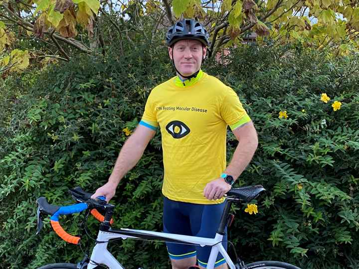Simon Jones in Macular Society top, with cycle.