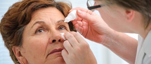 Woman receiving eye drops