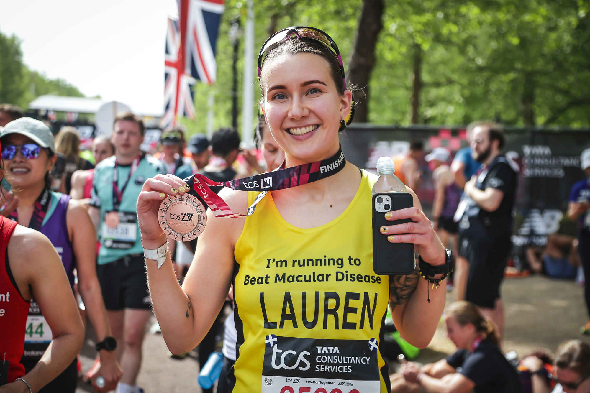 London Marathon 2026 runner Lauren smiling as she holds up her medal